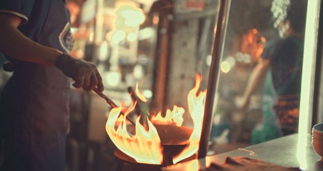 Wok being used to cook over a naked flame